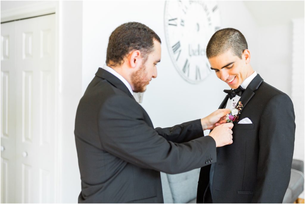 best man helping groom with bowtie, central pa wedding photographer