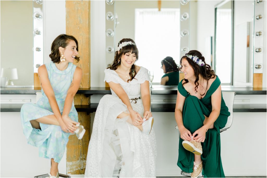 bride and bridesmaids putting on their shoes