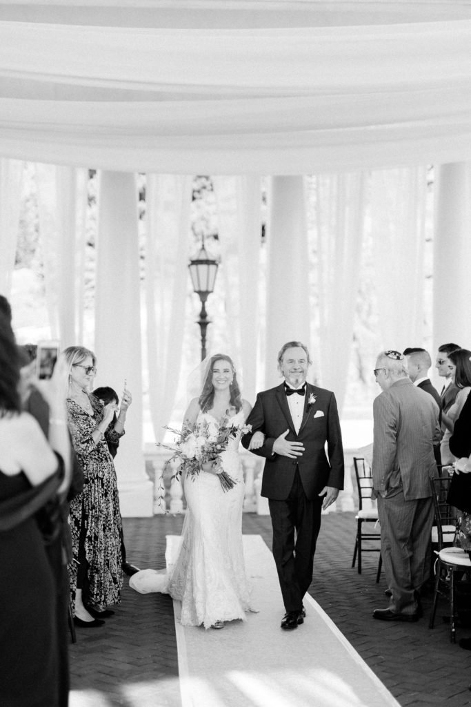 bride walking down aisle with her dad